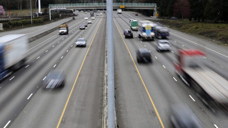 FILE - Cars and trucks travel on Interstate 5 near Olympia, Wash., March 25, 2019. The government’s traffic safety agency said Thursday, June 22, 2023, that it will require heavy trucks and buses to include potentially life-saving automatic emergency braking equipment within five years. Automatic braking systems in heavy vehicles would prevent nearly 20,000 crashes a year and save at least 155 lives, the National Highway Traffic Safety Administration said. (AP Photo/Ted S. Warren, File)