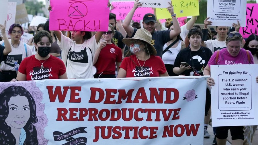 FILE - Thousands of protesters march around the Arizona Capitol after the Supreme Court decision to overturn the landmark Roe v. Wade abortion decision Friday, June 24, 2022, in Phoenix. (AP Photo/Ross D. Franklin, File)