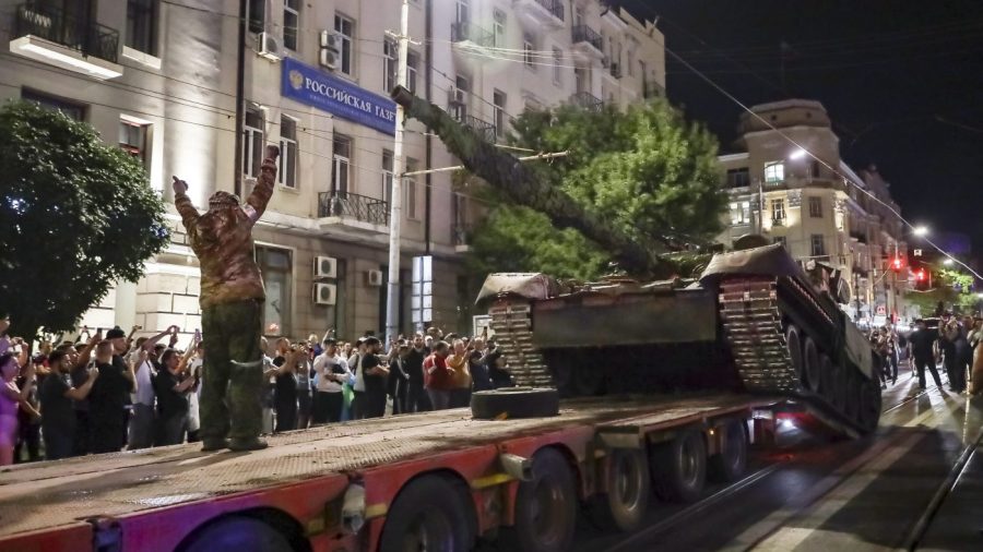 Members of the Wagner Group military company load their tank onto a truck on a street in Rostov-on-Don, Russia, Saturday, June 24, 2023, prior to leaving an area at the headquarters of the Southern Military District. Kremlin spokesman Dmitry Peskov said that Yevgeny Prigozhin's troops who joined him in the uprising will not face prosecution and those who did not will be offered contracts by the Defense Ministry. After the deal was reached Saturday, Prigozhin ordered his troops to halt their march on Moscow and retreat to field camps in Ukraine, where they have been fighting alongside Russian troops. (AP Photo)