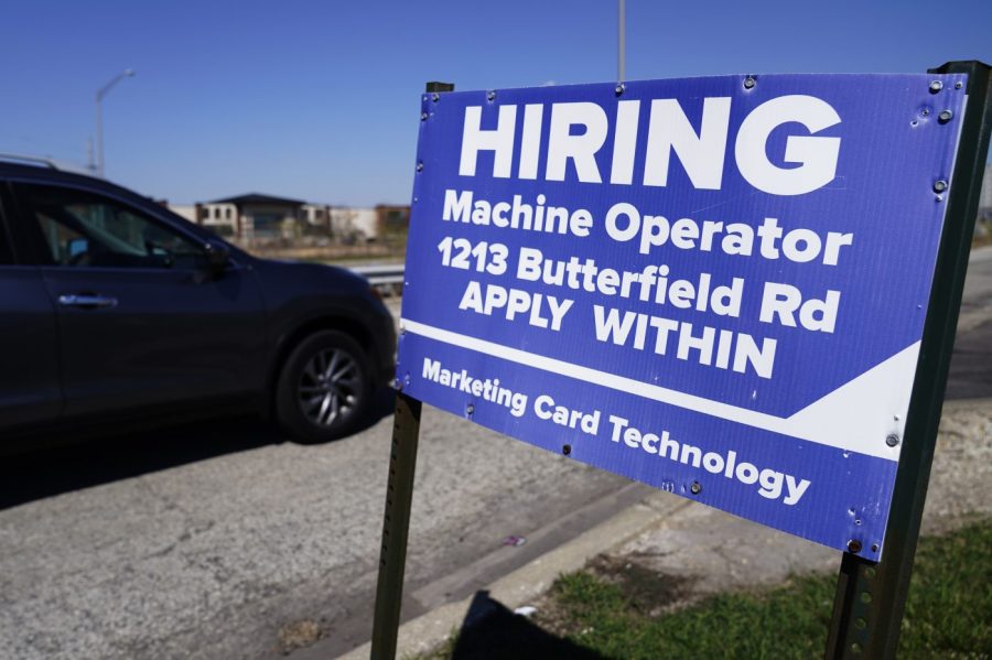 A hiring sign is seen in Downers Grove, Ill., Wednesday, April 12, 2023. On Thursday, the Labor Department reports on the number of people who applied for unemployment benefits last week. (AP Photo/Nam Y. Huh)