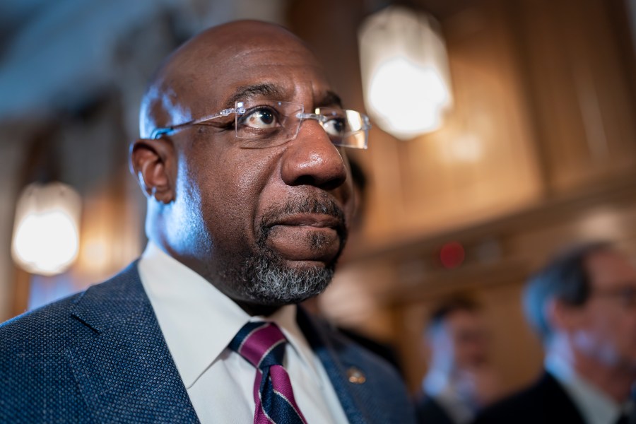 FILE - Sen. Raphael Warnock, D-Ga., arrives at the chamber for the final votes of the week, at the Capitol in Washington, Thursday, June 15, 2023. Georgia is offering a new bargain to some adults without health insurance beginning Saturday Saturday, July 1, 2023, — go to work or school and the state will cover you. But advocates, like Warnock, decry the plan, which will insure far fewer people than a full expansion of the state-federal Medicaid program, as needlessly restrictive and expensive. (AP Photo/J. Scott Applewhite, File)