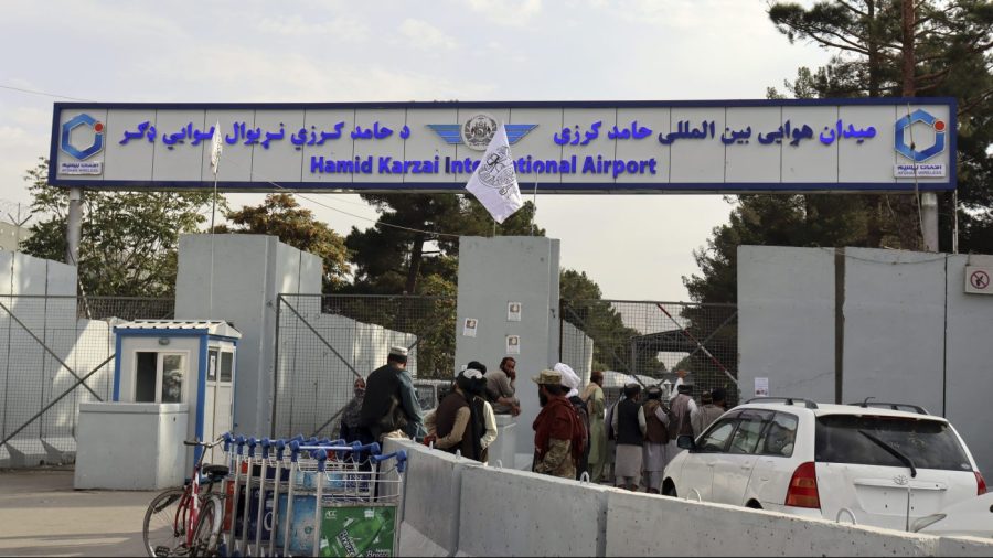 FILE - Taliban fighters stand guard in front of the Hamid Karzai International Airport after the U.S. withdrawal in Kabul, Afghanistan, Aug. 31, 2021. A State Department report says the department failed to do enough contingency planning before the collapse of the U.S.-backed government in Afghanistan. The review repeatedly blames the administration of former President Donald Trump for not doing enough planning or processing of visas after beginning the withdrawal. (AP Photo/Khwaja Tawfiq Sediqi, File)