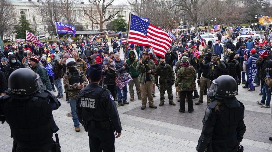 U.S. Capitol Police officers stand outside a door on the Senate side of the U.S. Capitol as rioters storm the capitol on Jan. 6, 2021, in Washington.