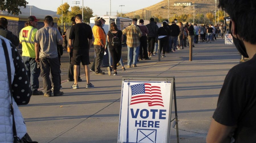 People wait to vote in-person at Reed High School in Sparks, Nev., prior to polls closing on Nov. 3, 2020.