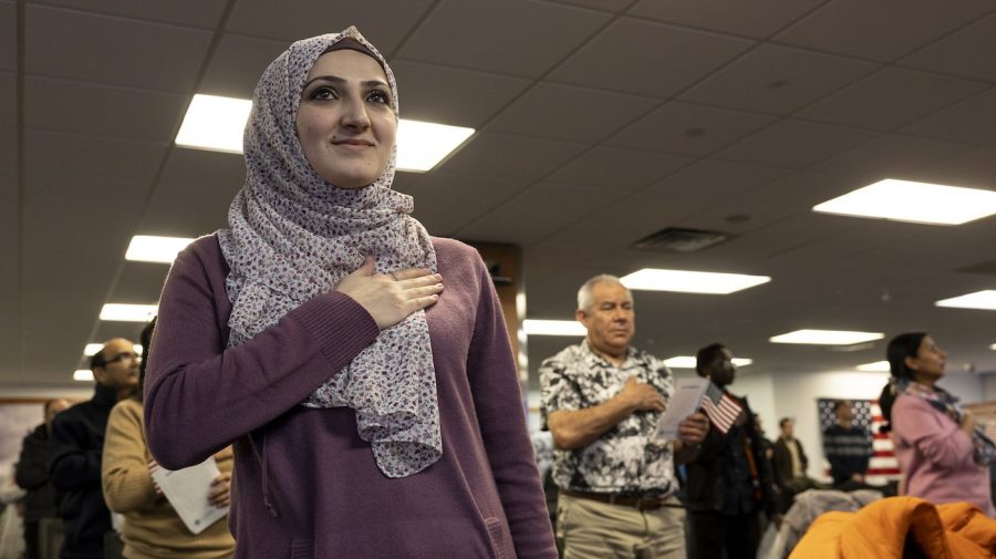 An immigrant from Jordan recites the Pledge of Allegiance at a naturalization ceremony on February 01, 2023 in Newark, New Jersey. Thirty-five people became American citizens at the event held by U.S. Citizenship and Immigration Services at the Federal Building in Newark. (Photo by John Moore/Getty Images)