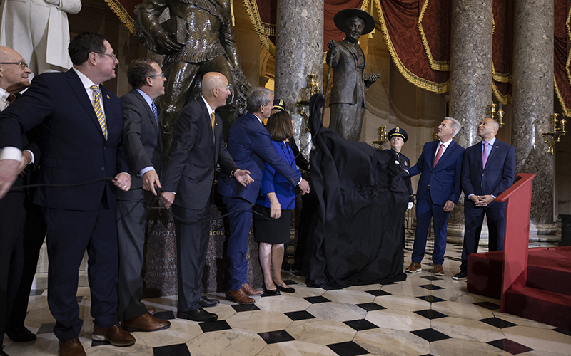 Congressional members from Nebraska and Gov. James Pillen (R) pull away a piece of fabric to reveal the statue in honor of Willa Cather for Statuary Hall