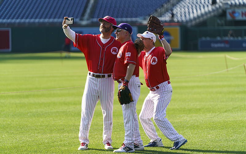 Dressed in red baseball uniforms, Reps. Tim Burchett (R-Tenn.), Steve Scalise (R-La.) and Greg Murphy (R-N.C.) take a selfie before the Congressional Baseball Game