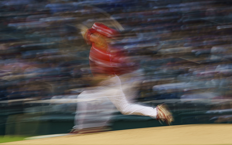 A motion blur shows Rep. Greg Steube (R-Fla.) pitches during the Congressional Baseball Game