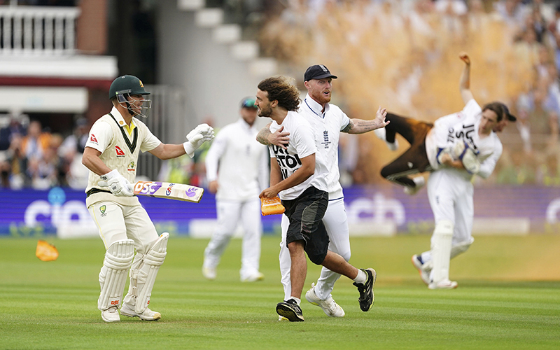 England's Ben Stokes grabs a Just Stop Oil protestor