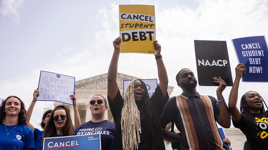 Student debt relief advocates gather outside the Supreme Court