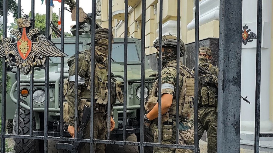 Servicemen of the Wagner Group military company guard an area at the headquarters of the Southern Military District in Rostov-on-Don, Russia, Saturday, June 24, 2023.