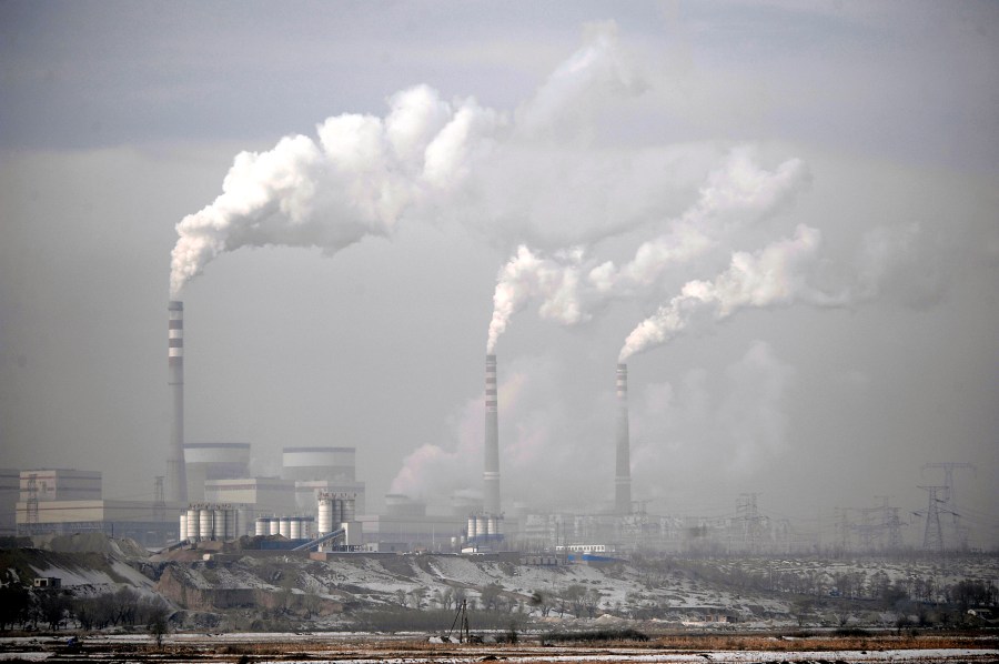 FILE - Smoke billows from chimneys of the cooling towers of a coal-fired power plant in Dadong, Shanxi province, China, Dec. 3, 2009. Frans Timmermans, the European Union’s climate chief, expressed concern over the expansion of China’s coal industry at a conference in Beijing on Monday, July 3, 2023. (AP Photo/Andy Wong, File)