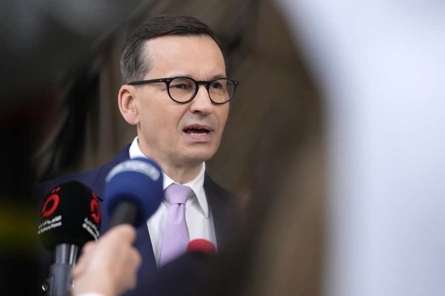 Poland's Prime Minister Mateusz Morawiecki speaks with the media as he arrives for an EU summit at the European Council building in Brussels, Friday, June 30, 2023. European Union leaders wrap-up a two day summit on Friday in which they will discuss Ukraine, Migration and China. (AP Photo/Virginia Mayo)