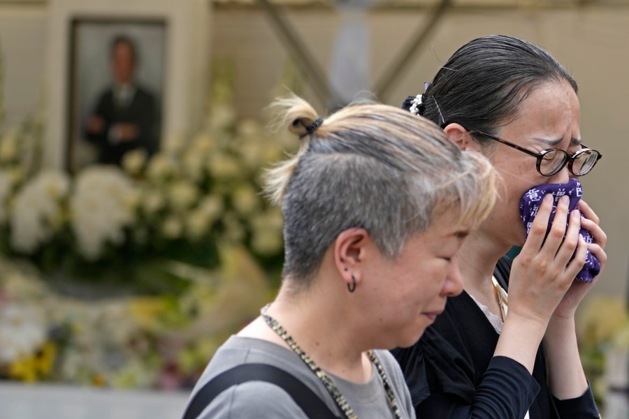 People react after offering prayer for former Prime Minister Shinzo Abe at Zojoji temple in Tokyo, Japan, Saturday, July 8, 2023. Japan marked first anniversary of the death of Abe who was shot while giving an outdoor campaign speech.(AP Photo/Shuji Kajiyama)