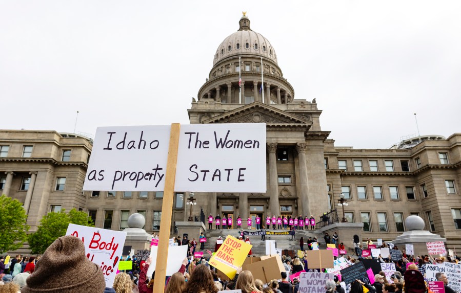 FILE - An attendee at Planned Parenthood's Bans Off Our Bodies rally for abortion rights holds a sign reading outside of the Idaho Statehouse in downtown Boise, Idaho, on May 14, 2022. Two advocacy groups and an attorney who works with sexual assault victims are suing Idaho over a new law that makes it illegal to help minors get an abortion without their parents’ consent. (Sarah A. Miller/Idaho Statesman via AP, File)