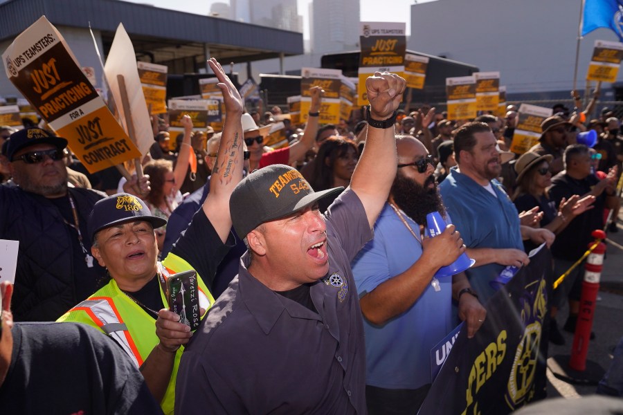 FILE - UPS teamsters and workers hold a rally in downtown Los Angeles, Wednesday, July 19, 2023, as a national strike deadline nears. The Teamsters said Wednesday that they will resume contract negotiations with UPS next week, marking an end to a stalemate that began two weeks ago when both sides walked away from talks while blaming each other. (AP Photo/Damian Dovarganes, File)