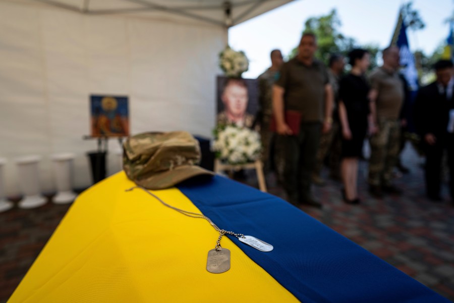 A military token is seen on the coffin of U.S. citizen and Army veteran, Nicholas Maimer who was killed during fighting in Bakhmut against Russian forces, in Ukrajinka, Ukraine, Wednesday, July 19, 2023. (AP Photo/Evgeniy Maloletka)