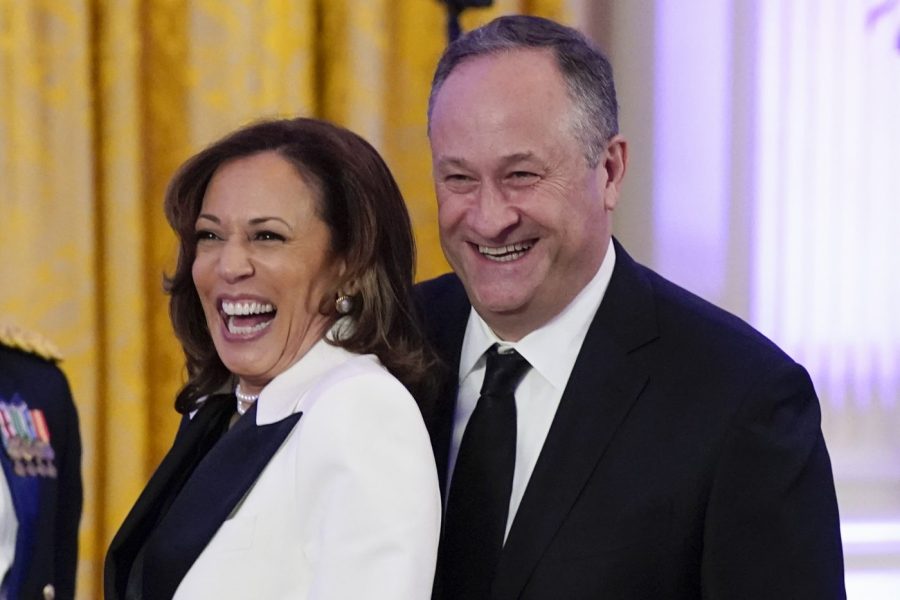 FILE - Vice President Kamala Harris and her husband Doug Emhoff arrive in the East Room of the White House following a dinner reception for the governors and their spouses on Feb. 11, 2023, in Washington. Emhoff met with former New Zealand Prime Minister Jacinda Ardern Friday, July 21, to discuss ways to combat online hate and extremism. (AP Photo/Manuel Balce Ceneta, File)