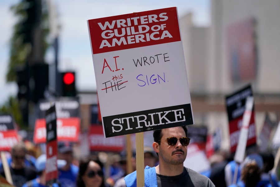 FILE - Members of the The Writers Guild of America picket outside Fox Studios on Tuesday, May 2, 2023, in Los Angeles. Getting control of the use of artificial intelligence is a central issue in the current strikes of Hollywood's actors and writers, which on Friday, July 21, 2023, entered its second week. (AP Photo/Ashley Landis, File)