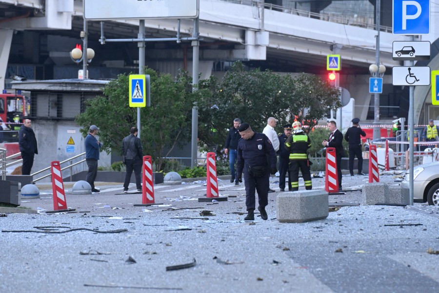 Investigators examine an area next to the damaged skyscraper in the "Moscow City" business district after a reported drone attack in Moscow, Russia, early Sunday, July 30, 2023. (AP Photo)