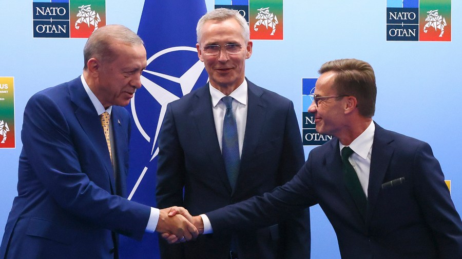 Turkey's President Recep Tayyip Erdogan, left, shakes hands with Sweden's Prime Minister Ulf Kristersson, right, as NATO Secretary General Jens Stoltenberg looks on prior to a meeting ahead of a NATO summit in Vilnius, Lithuania, Monday, July 10, 2023. (Yves Herman, Pool Photo via AP)