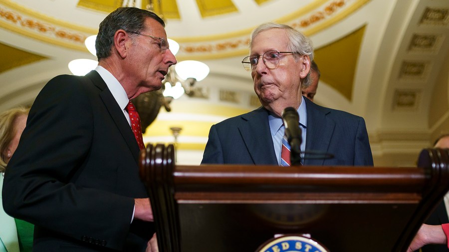 Minority Leader Mitch McConnell (R-Ky.) is helped by Sen. John Barrasso (R-Wyo.) after McConnell unexpectedly pauses while speaking to reporters after the weekly policy luncheon