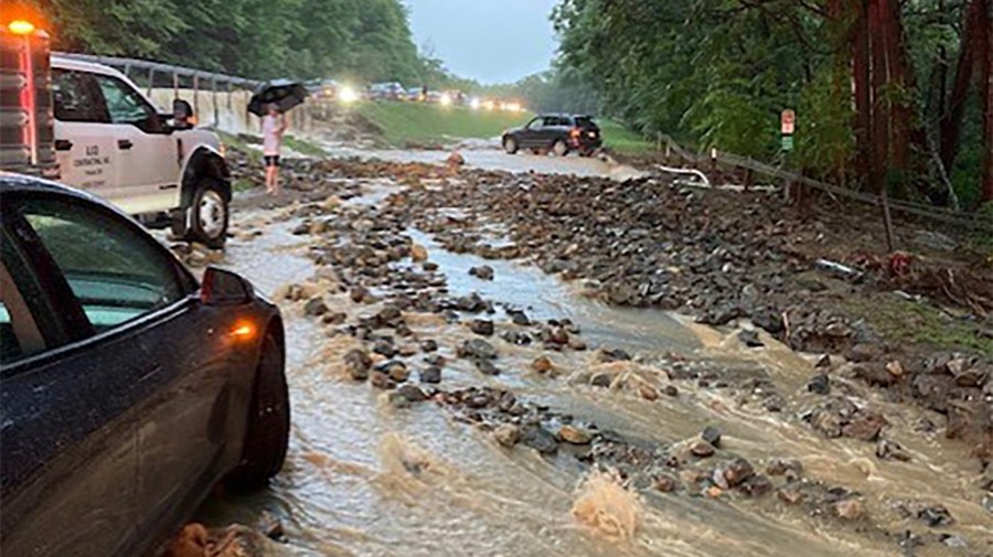 Vehicles come to a standstill near a washed-out and flooded portion of the Palisades Parkway just beyond the traffic circle off the Bear Mountain Bridge, Sunday, July 9, 2023, in Orange County, N.Y. Heavy rain spawned extreme flooding in New York’s Hudson Valley that killed at least one person, swamped roadways and forced road closures on Sunday night, as much of the rest of the Northeast U.S. geared up for a major storm.