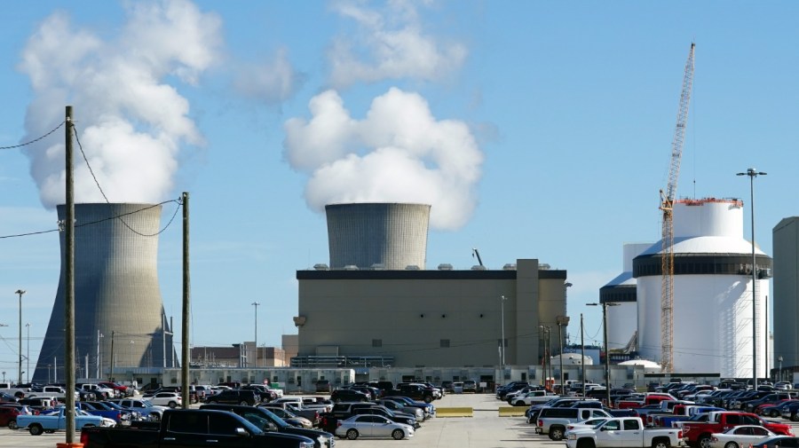 Reactors for Unit 3 and 4 sit at Georgia Power's Plant Vogtle nuclear power plant on Jan. 20, 2023, in Waynesboro, Ga., with the cooling towers of older Units 1 and 2 billowing steam in the background. Company officials announced Wednesday, May 24, 2023, that Unit 3 would reach full power in coming days, after years of delays and billions in cost overruns. (AP Photo/John Bazemore)