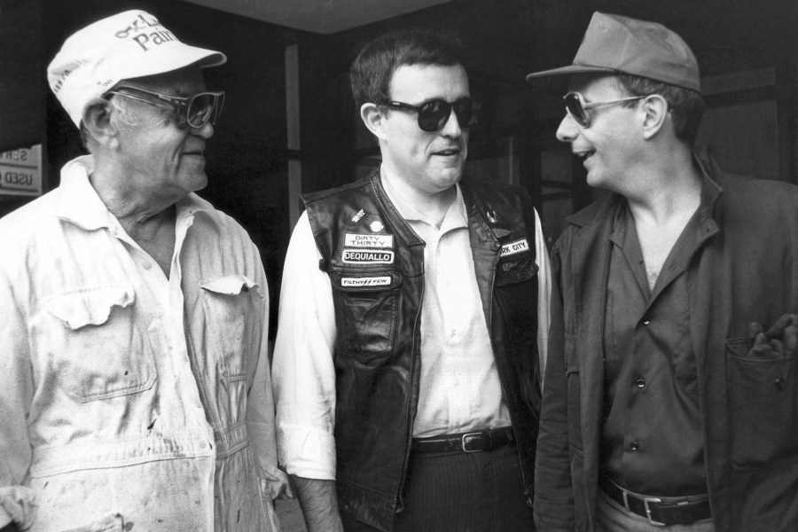 FILE — U.S. Sen. Alfonse D' Amato, right, U.S. Attorney Rudolph Giuliani, center, and Benjamin Baer, chairman of the U.S. Parole Commission, pose in their undercover clothes, July 9, 1986, after D'Amato bought what he later told a news conference were vials of "crack" on a Manhattan street. Giuliani, once warmly regarded as "America's Mayor" in the wake of the 9/11 attacks, and who first rose to prominence as a federal prosecutor going after mobsters with a then-novel approach to racketeering cases, has seen his reputation tumble and his liberty threatened in defense of Donald Trump's bogus election fraud claims.(AP Photo/Richard Drew, File)