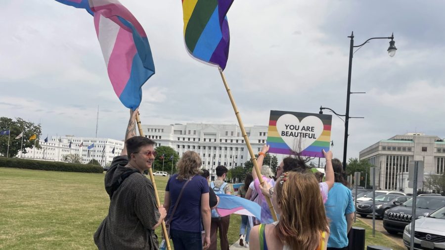 FILE - Connor McMahon, left, and Regan Collins walk in a rally outside the Alabama Statehouse in Montgomery, Ala. on International Transgender Day of Visibility, Friday, March 31, 2023. On Monday, Aug. 21, a federal appeals court ruled that Alabama can enforce a ban outlawing the use of puberty blockers and hormones to treat transgender children, the second such appellate victory for gender-affirming care restrictions that have been adopted by a growing number of Republican-led states. (AP Photo/Kim Chandler, File)