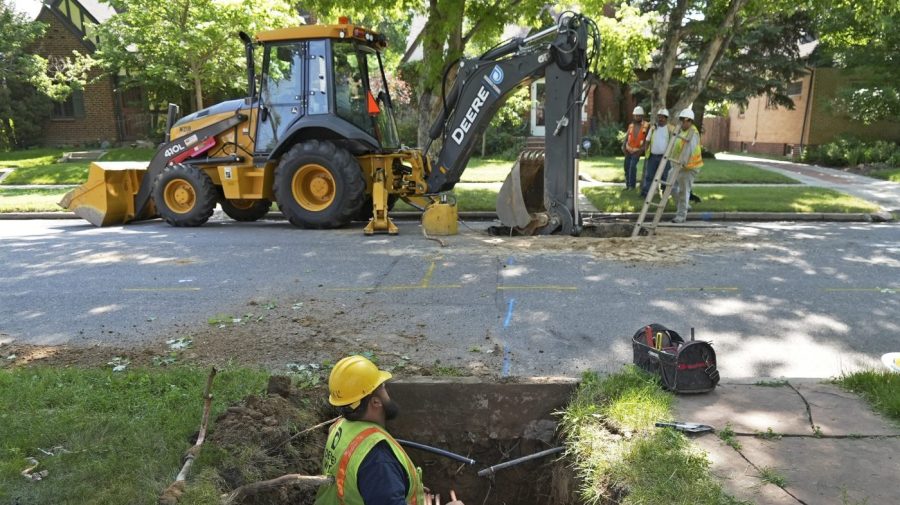 FILE - A Denver Water crew works to replace a lead water service line installed in 1927 with a new copper one at a private home on June 17, 2021, in Denver. As the Biden administration makes billions of dollars available to remove millions of dangerous lead water pipes that can contaminate drinking water and damage brain development in children, some states are turning down funds. (AP Photo/Brittany Peterson, File)