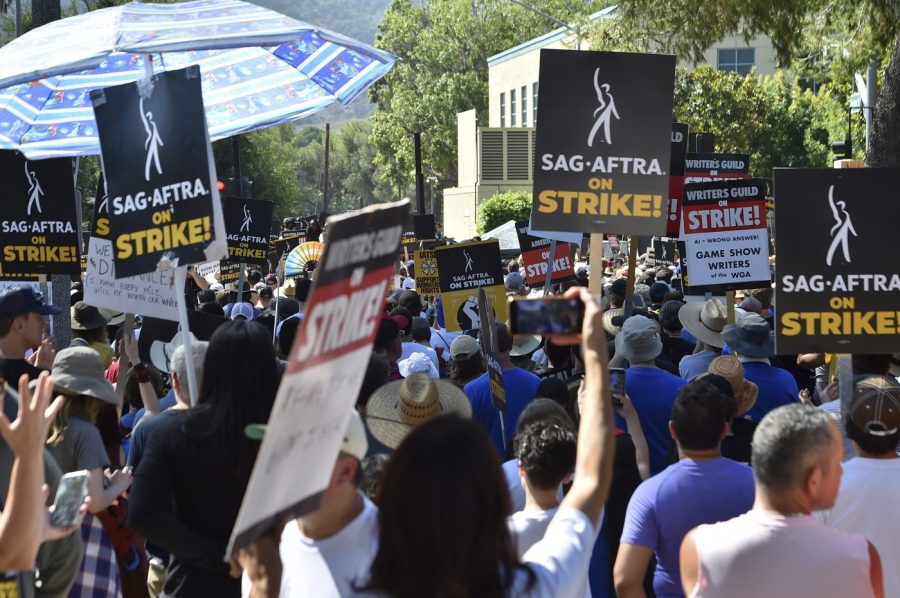 Attendees march at the Day of Solidarity union rally on Tuesday, Aug. 22, 2023, at Disney Studios in Burbank, Calif. The event includes members of SAG-AFTRA, the WGA and the AFL-CIO. (Photo by Jordan Strauss/Invision/AP)