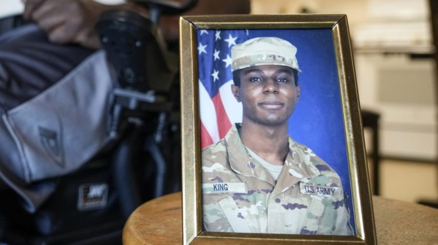 FILE - A portrait of American soldier Travis King is displayed as his grandfather, Carl Gates, talks about his grandson on July 19, 2023, in Kenosha, Wis. The Biden administration is extending for another year a ban on the use of U.S. passports for travel to North Korea, the State Department said Tuesday. The latest extension comes as tensions with North Korea are rising over its nuclear and ballistic missile programs and the uncertain status of Travis King, a U.S. service member who last month entered the country through its heavily armed border. (AP Photo/Morry Gash, File)