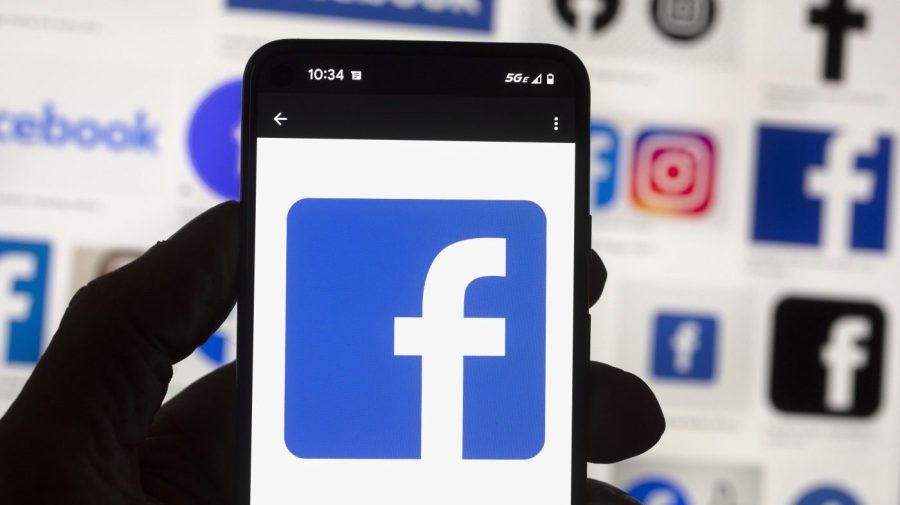 FILE - The Facebook logo is seen on a cell phone, Friday, Oct. 14, 2022, in Boston. Google, Facebook, TikTok and other Big Tech companies operating in Europe are facing one of the most far-reaching efforts to clean up what people encounter online. (AP Photo/Michael Dwyer, File)