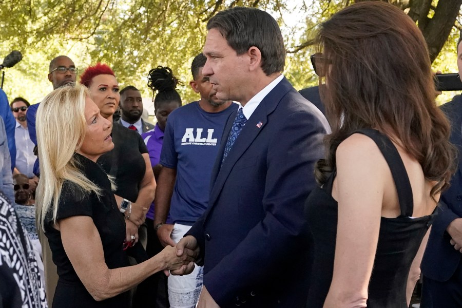 Jacksonville Mayor Donna Deegan, left, greets Florida Gov. Ron DeSantis, center and his wife Casey, right, before a prayer vigil for the victims of Saturday's mass shooting Sunday, Aug. 27, 2023, in Jacksonville, Fla. (AP Photo/John Raoux)