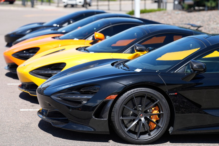 A line of used luxury sports coupes sits outside at a McLaren dealership Sunday, Aug 27, 2023, in Highlands Ranch, Colo. Inflation in the United States edged up in July after 12 straight months of declines. (AP Photo/David Zalubowski)