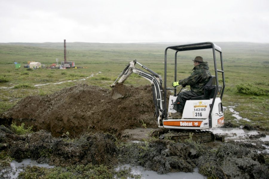 FILE - A worker with the Pebble Mine project digs in the Bristol Bay region of Alaska near the village of Iliamma, Alaska, July 13, 2007. Environmental Protection Agency Administrator Michael Regan said he fully supports his agency's decision to block a proposed gold and copper mine in Alaska's salmon-rich Bristol Bay in a telephone interview with The Associated Press on Tuesday, Aug. 29, 2023. (AP Photo/Al Grillo, File)