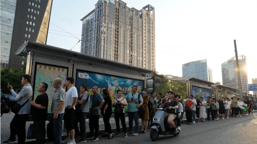 Residents line up for public transportation in Beijing, Tuesday, Aug. 15, 2023. Chinese leader Xi Jinping has called for patience in a speech released as the ruling Communist Party tries to reverse a deepening economic slump and said Western countries are "increasingly in trouble" because of their materialism and "spiritual poverty." (AP Photo/Ng Han Guan)