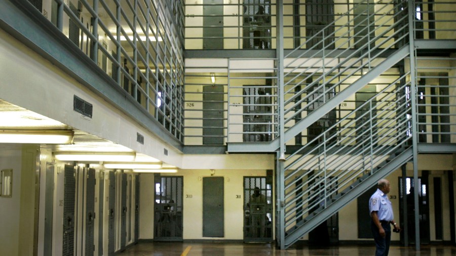 In this photo taken Monday, Aug. 10, 2009, an Arkansas Department of Correction officer patrols a cell block at the agency's Cummins Unit near Varner, Ark. (AP Photo/Danny Johnston)