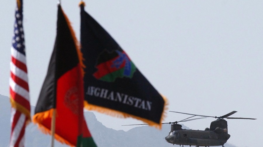 A helicopter of Coalition Joint Task Force arrives during a transfer of authority ceremony at Bagram Air Base, the headquarters of coalition forces in Afghanistan, Tuesday, May 27, 2003. Maj. Gen. John R. Vines became the new commander of U.S. coalition forces in Afghanistan, replacing Lt. Gen. Dan K. McNeill. (AP Photo/Rafiq Maqbool)