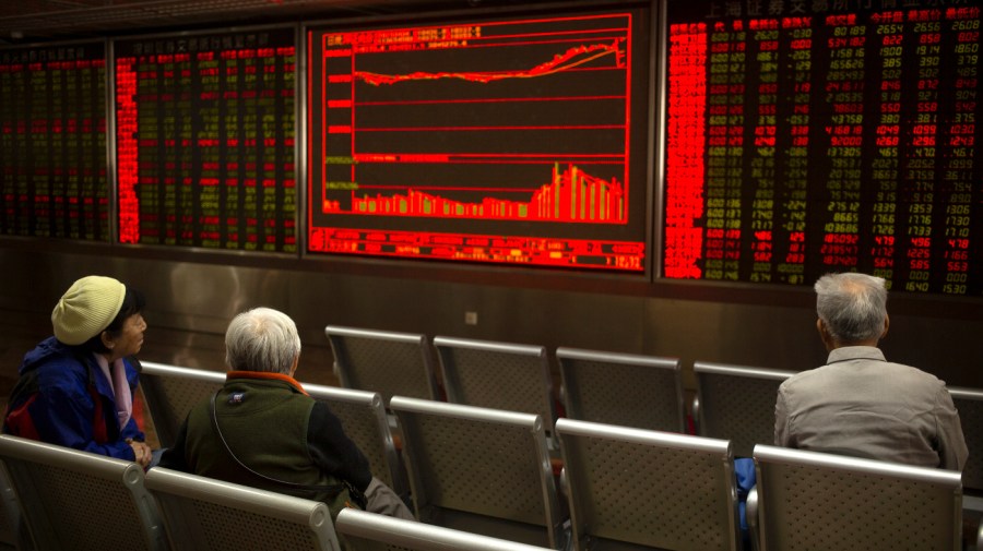 Chinese investors monitor stock prices at a brokerage house in Beijing, Thursday, April 4, 2019.