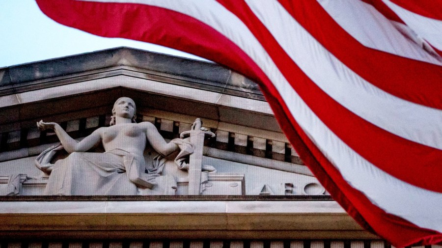 An American flag flies outside the Department of Justice in Washington, March 22, 2019. (AP Photo/Andrew Harnik, File)