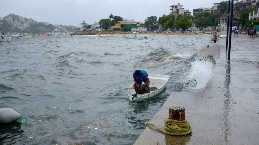 A man moors his boat in Acapulco, Guerrero State, Mexico, on August 16, 2023, following the passage of Tropical Storm Hilary.