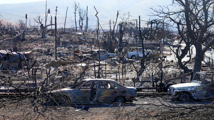 Destroyed homes and cars are shown, Sunday, Aug. 13, 2023, in Lahaina, Hawaii.