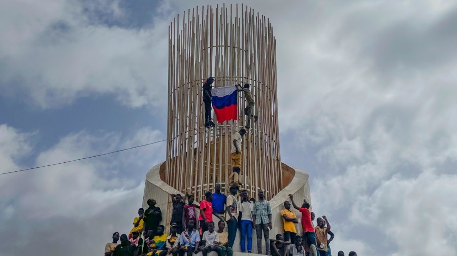 Supporters of Niger's ruling junta hold a Russian flag at the start of a protest called to fight for the country's freedom and push back against foreign interference in Niamey, Niger, Thursday, Aug. 3, 2023. The march falls on the West African nation's independence day from its former colonial ruler, France, and as anti-French sentiment spikes, more than one week after mutinous soldiers ousted the country's democratically elected president. (AP Photo/Sam Mednick)