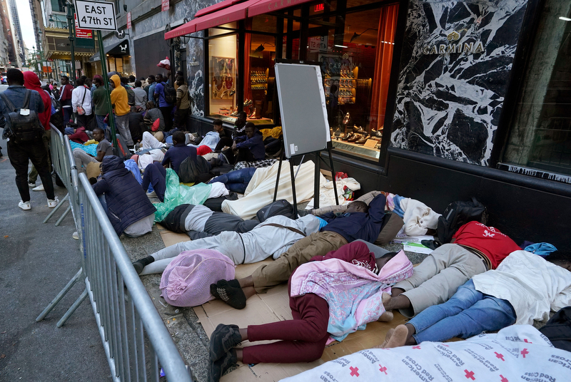 Hundreds of migrants sleep in line early on Aug. 1 for placement at the Roosevelt Hotel intake center in New York.