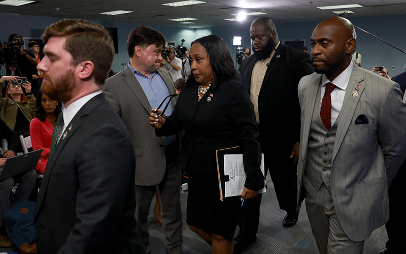 Fulton County District Attorney Fani Willis leaves after speaking at a news conference at the Fulton County Government building