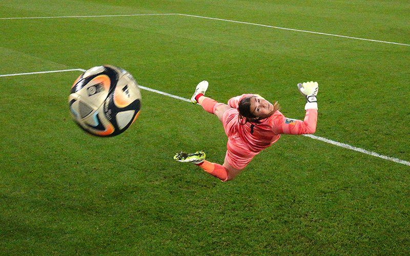 Mary Earps of England dives in vain as a soccer ball flies past her to score a goal