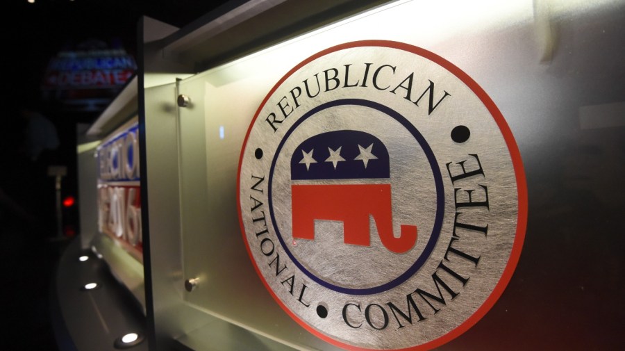 The Republican National Committee logo is seen illuminated on a wall.