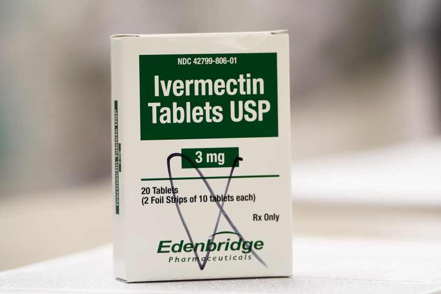 FILE -A box of ivermectin is shown in a pharmacy as pharmacists work in the background, Thursday, Sept. 9, 2021, in Ga. A federal appeals court Friday, Sept. 1, 2023 revived a lawsuit by three doctors who say the Food and Drug Administration overstepped its authority in a campaign against treating COVID-19 with the anti-parasite drug ivermectin(AP Photo/Mike Stewart, File)